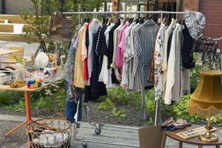 Clothes and other belongings at a yard sale.