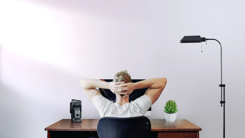 Man relaxing at his desk in a working from home office