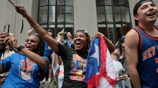 Fans cheer during the New York Knicks victory parade