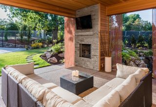 outdoor room with comfy sofas and waterproof TV on the wall