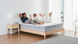 Ecosa Pure mattress in a simple stylised bedroom, with two people on the bed