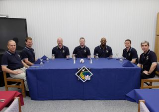 STS-122 mission crew members gather for the traditional breakfast at NASA's Kennedy Space Center before they launch on space shuttle Atlantis to the International Space Station. Around the table, from left, are Mission Specialists Hans Schlegel and Stanle