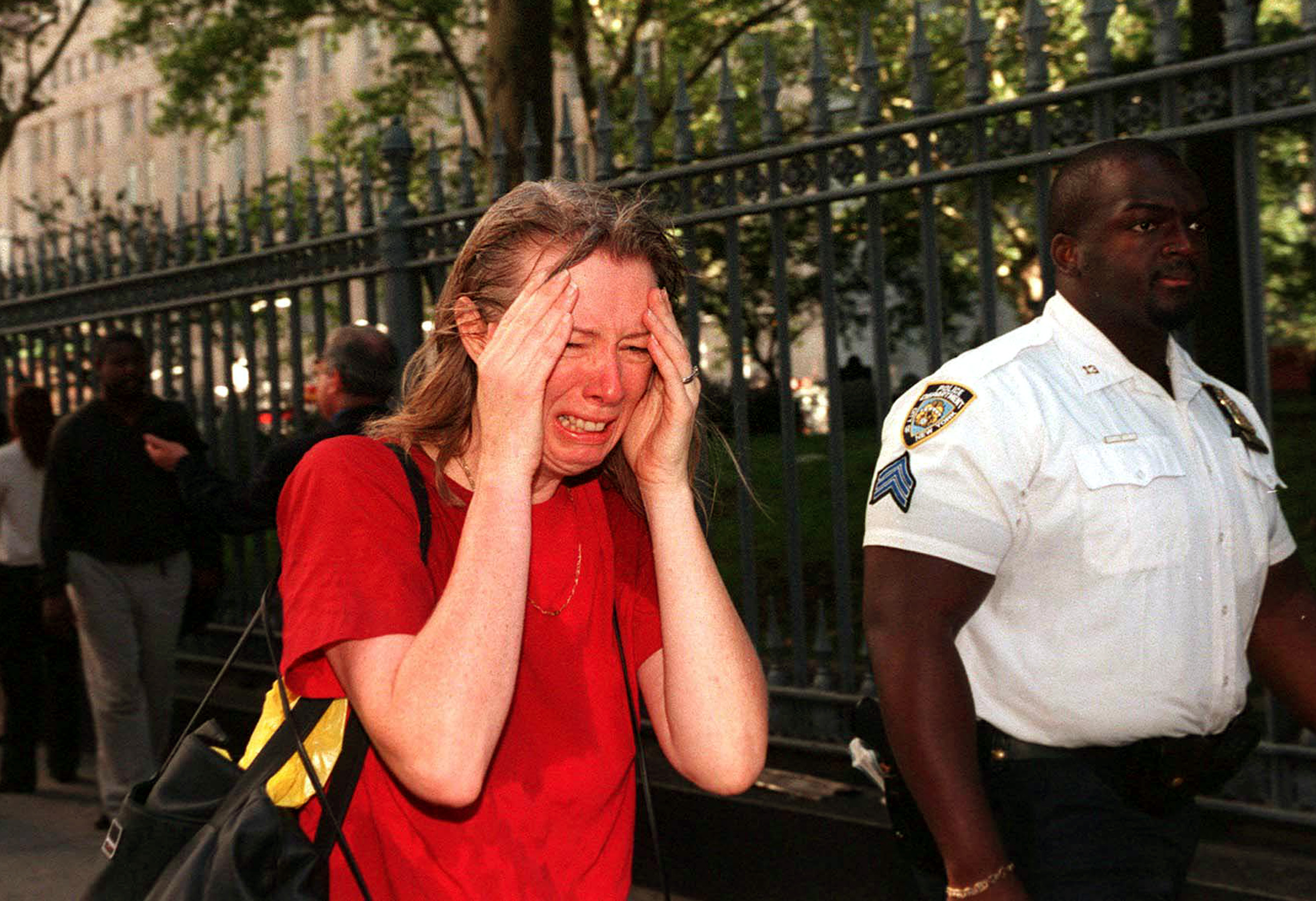Stunned woman fleeing the scene of the terrorist attack on the World Trade Center. (Photo by Jennifer S. Altman/WireImage) *** Local Caption ***