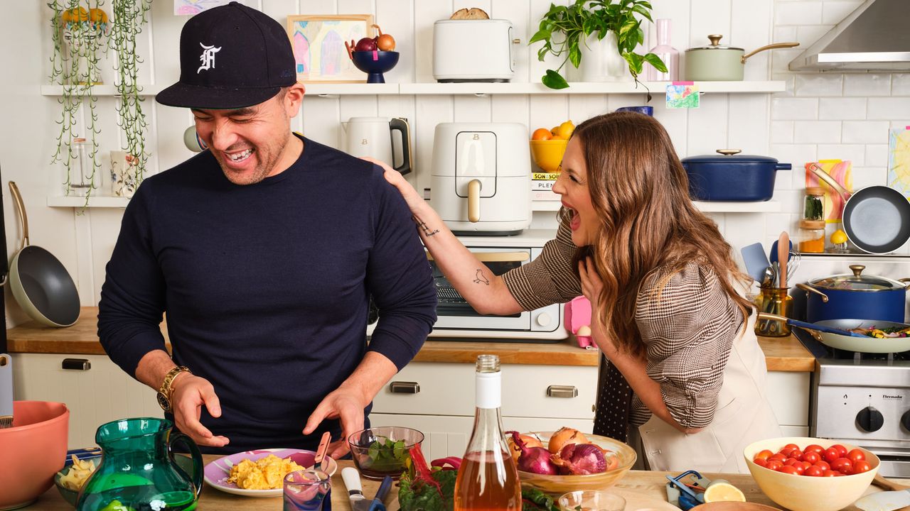 Drew Barrymore with Beautiful by Drew kitchenware and appliances laughing with Shae Hong