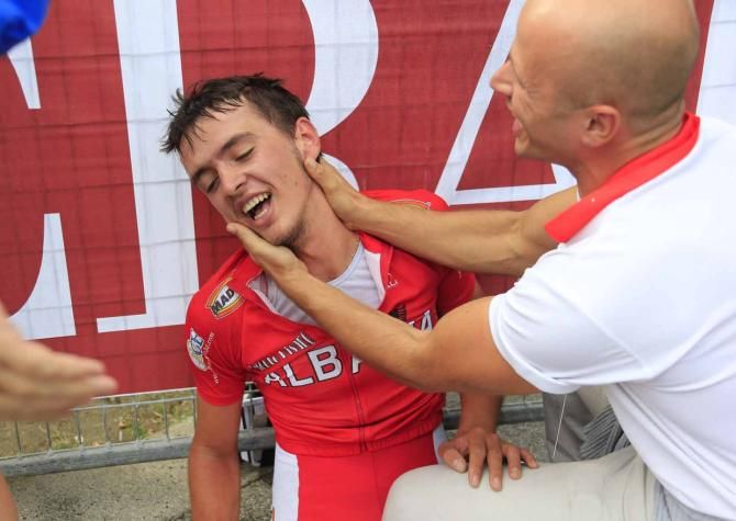 Iltjan Nika (Albania) is congratulated by his soigneur.