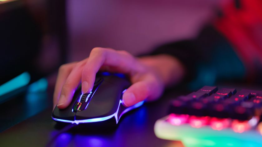 Peron using an RGB gaming mouse and keyboard at a desk