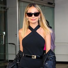 Nicole Richie wearing a black Saint Laurent halter top with sunglasses and a black-and-gold belt in NYC. 