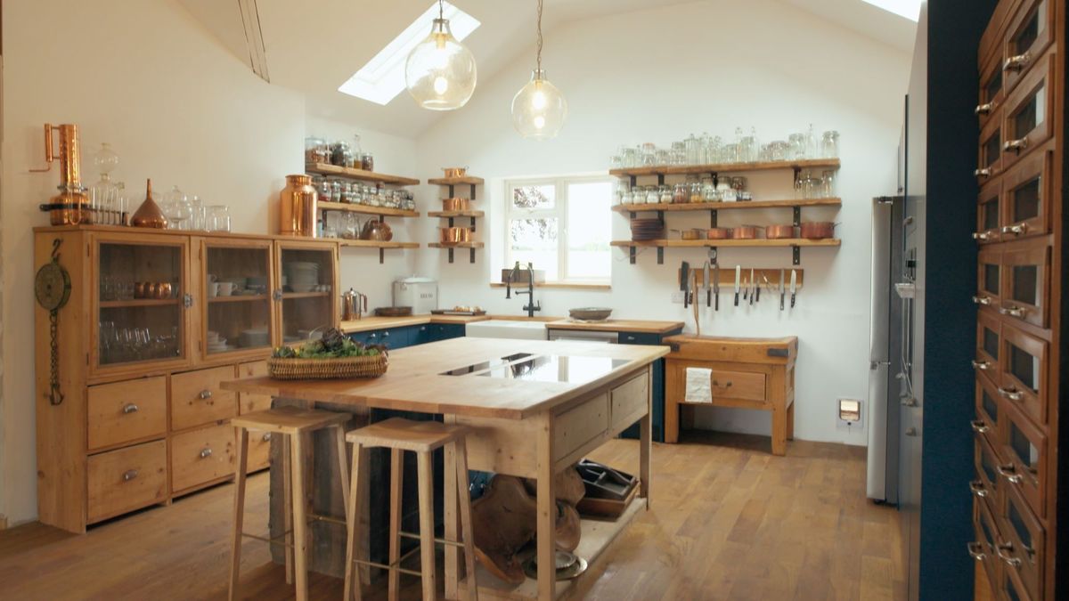 DIY kitchen island made from recycled cabinets in the middle of brightly lit kitchen.