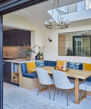 blue and yellow banquette seating in kitchen diner