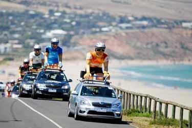 The TDU publicity caravan makes its way along the course.