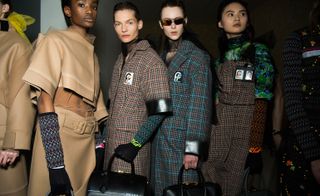 Models wear checkered and cropped coats, in camel, maroon and navy