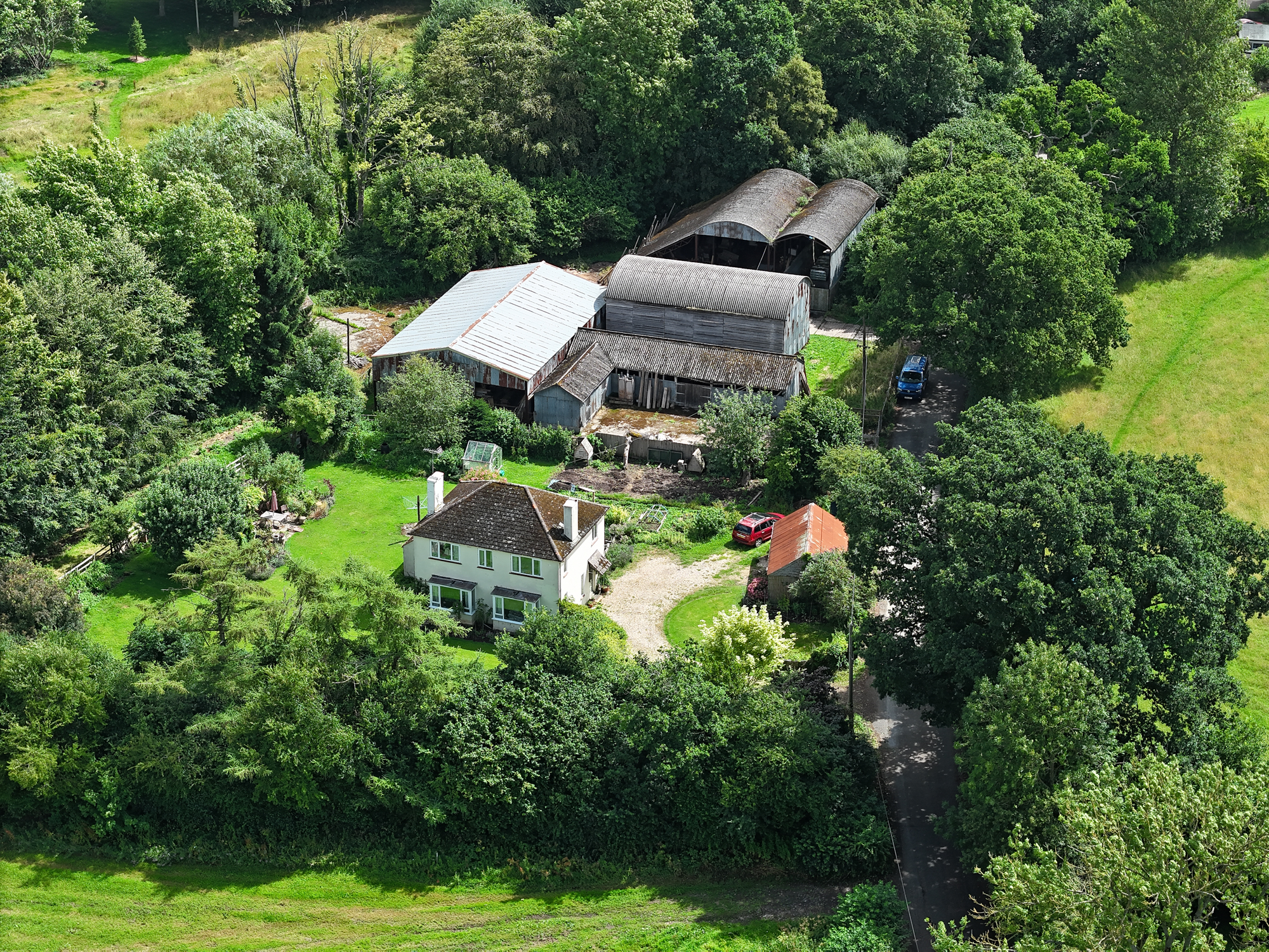 DJI Air 3 aerial photo of a rural home on a sunny day with the 70mm telephoto camera