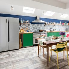green and blue kitchen with refrigerator dining table with chairs