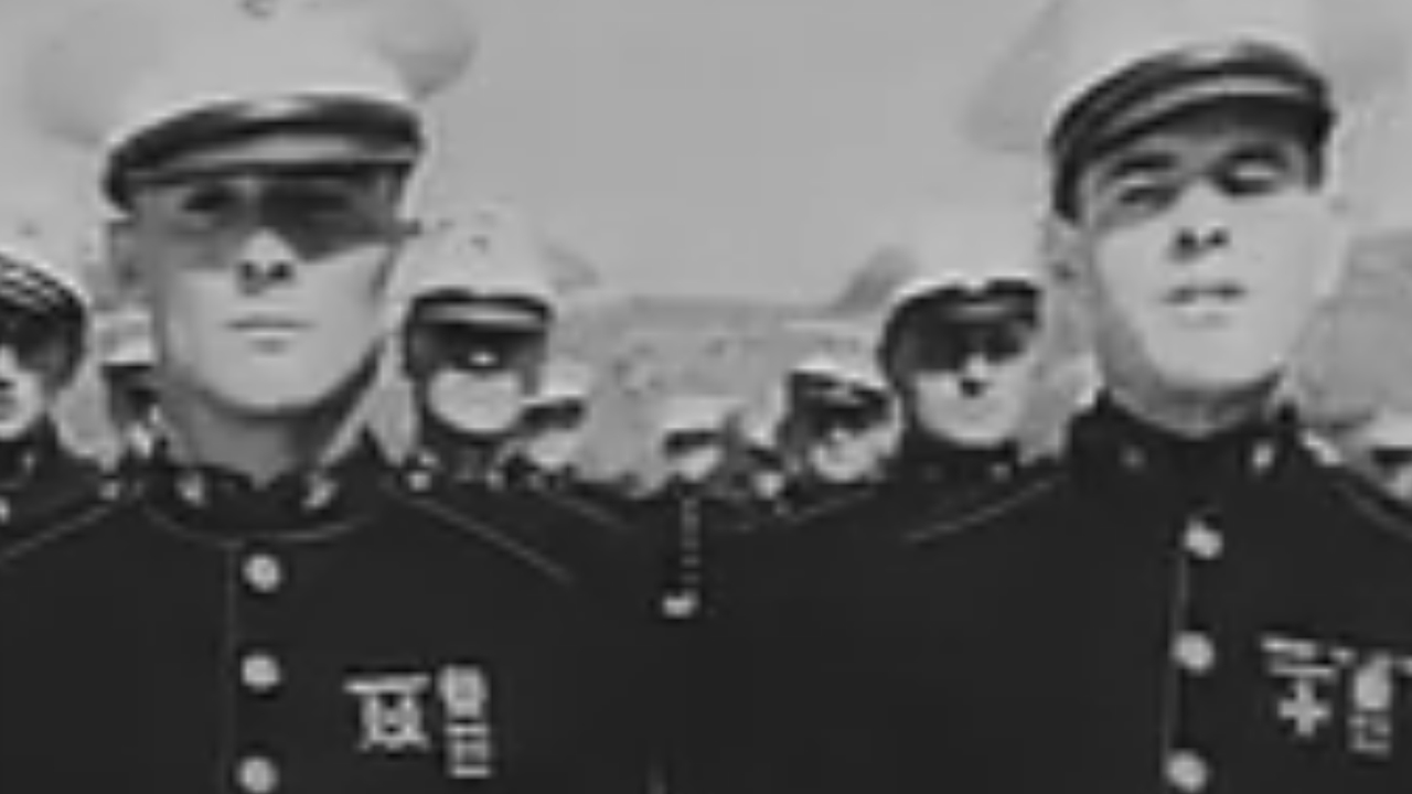 Two Marines in dress uniforms in The Marines Are Coming
