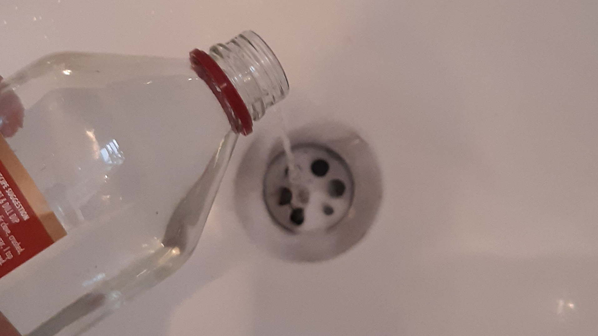 Vinegar poured in bath drain