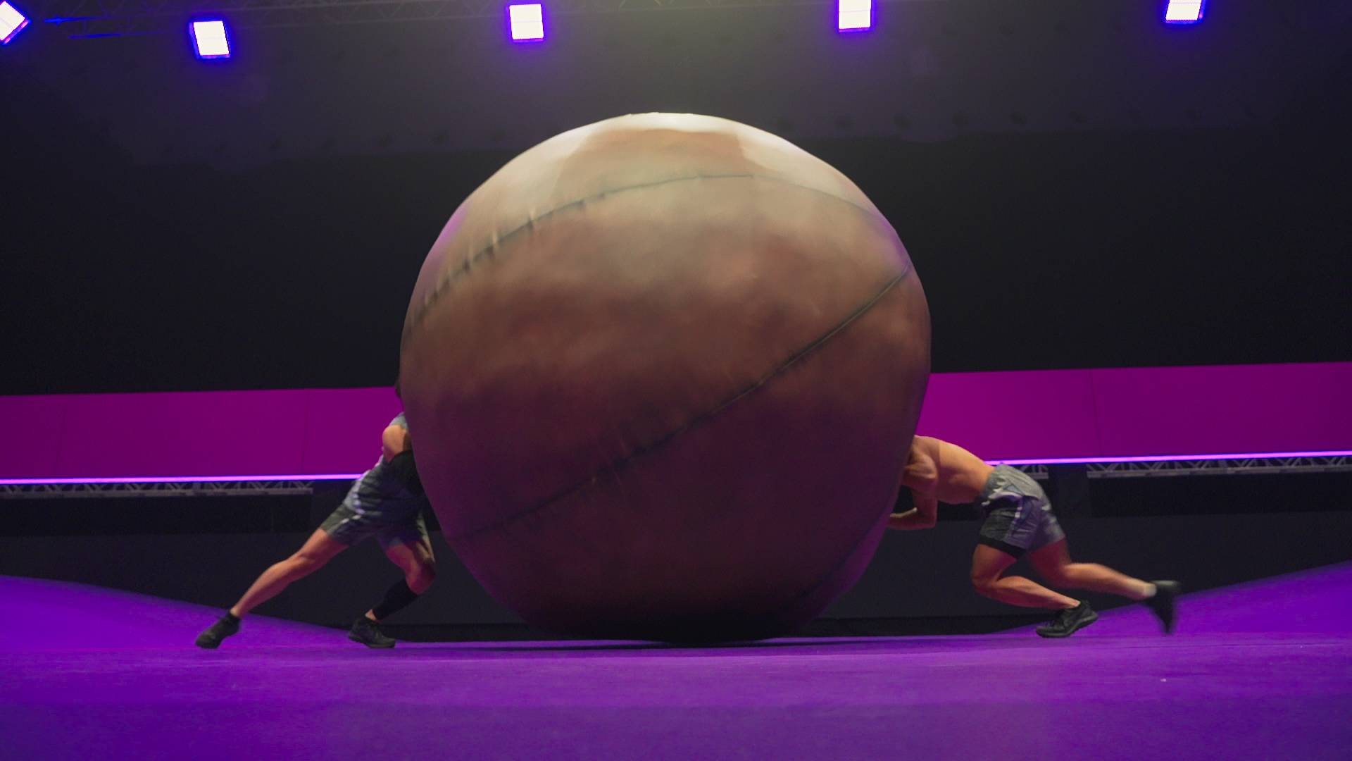 Two competitors pushing a ball on Netflix's Final Draft.