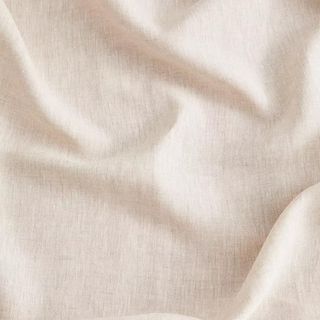 Closeup of neutral linen bed sheets
