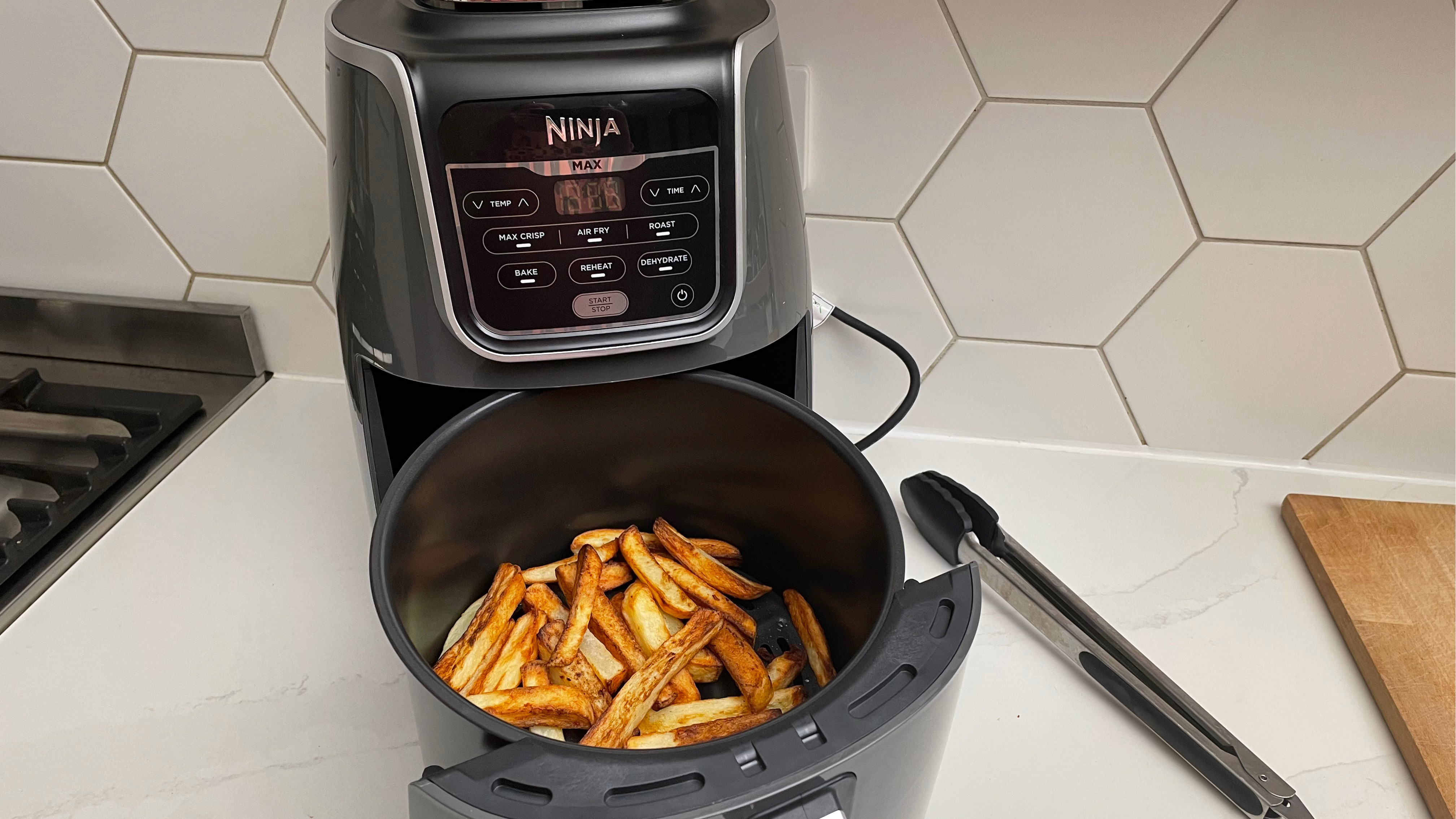 The Ninja Air Fryer Max AF160 with fries in the basket that have just been cooked in the air fryer