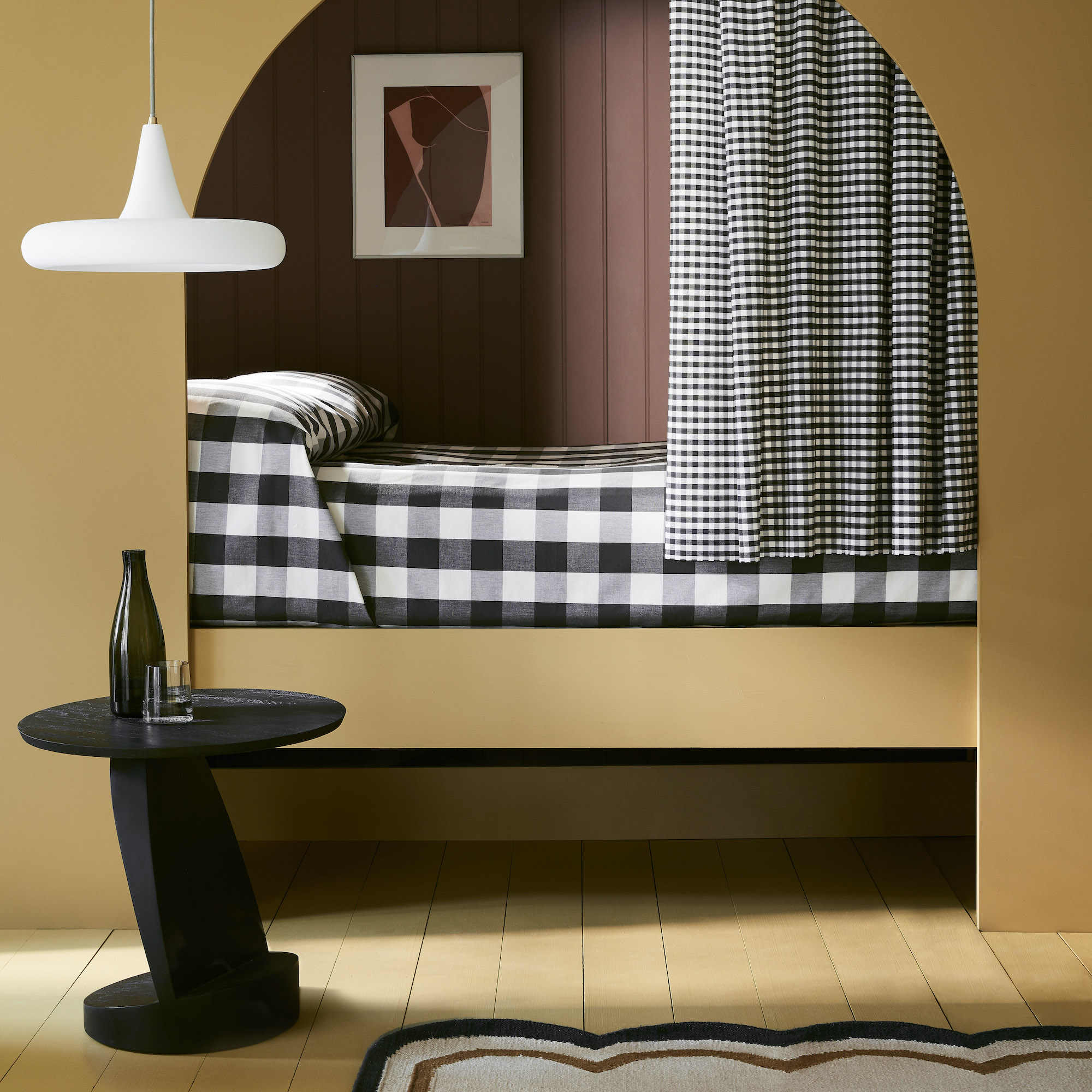 bedroom with arched bed in black and ochre