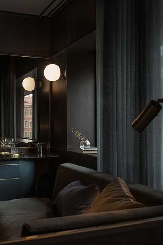 At Six — Stockholm, Sweden - sitting room with black sofa