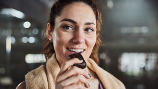 Woman eating protein bar