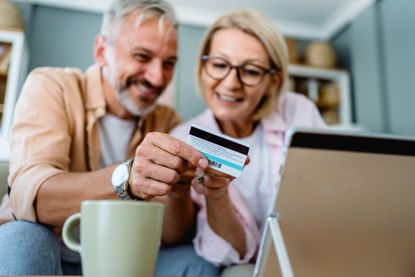 A couple shopping online on their tablet.