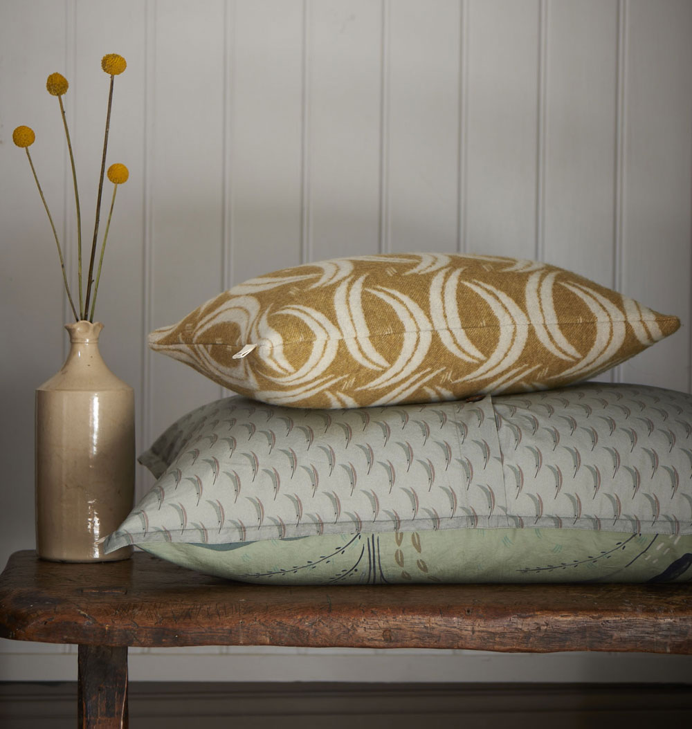 wooden table with cushions and vase