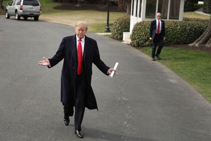 Trump walks at the White House