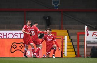 CRAWLEY, ENGLAND - JANUARY 10: Jordan Tunnicliffe of Crawley Town celebrates with teammates Tony Craig and Ashley Nadesan after scoring their team's third goal during the FA Cup Third Round match between Crawley Town and Leeds United at The Peoples Pension Stadium on January 10, 2021 in Crawley, England. Sporting stadiums around England remain under strict restrictions due to the Coronavirus Pandemic as Government social distancing laws prohibit fans inside venues resulting in games being played behind closed doors. (Photo by Mike Hewitt/Getty Images)