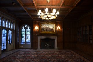 The painting above the fireplace, by Explorers Club member Albert Operti