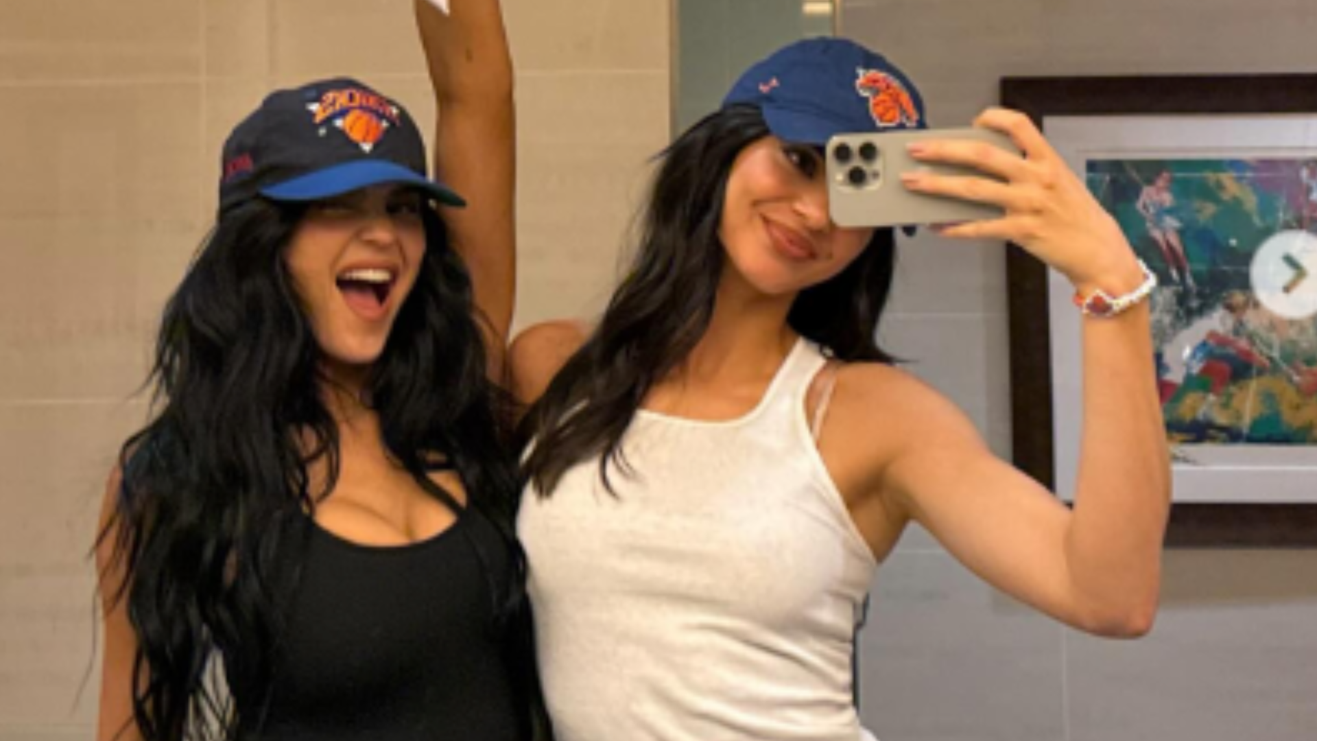 Kendall Jenner and Kylie Jenner wearing white and black tank tops.