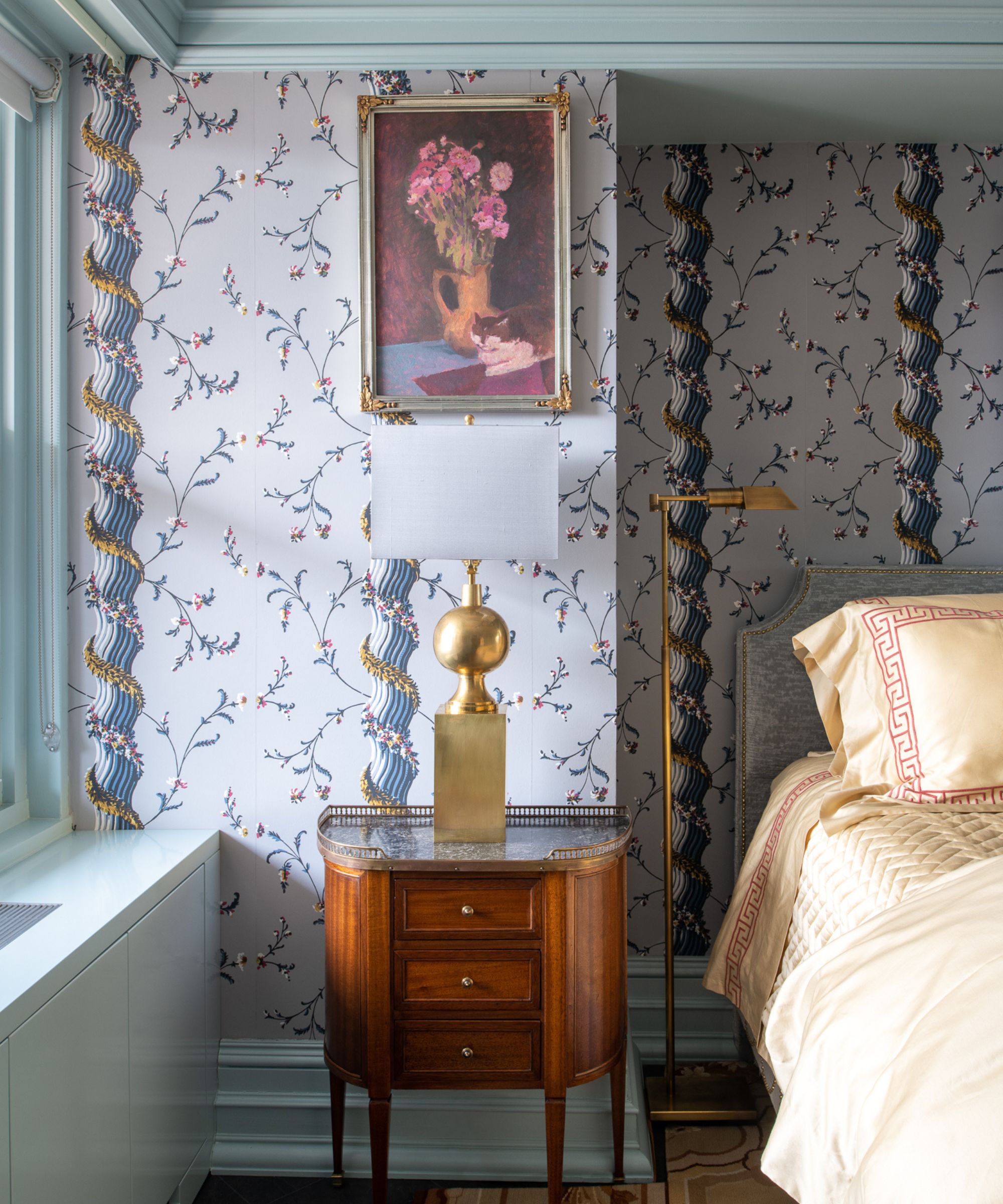 blue floral wallpapared bedroom with matching blue ceiling trim and woodwork