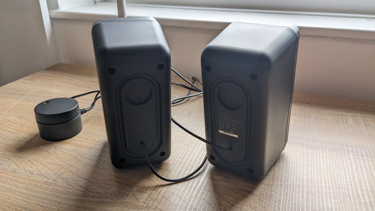The Trust GXT 611 Wezz RGB speakers pictured on a wooden desk.