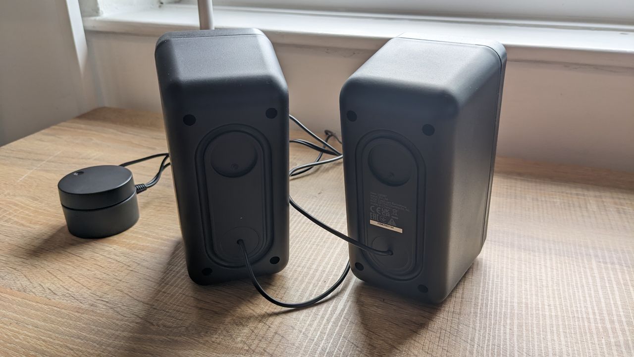 The Trust GXT 611 Wezz RGB speakers pictured on a wooden desk.