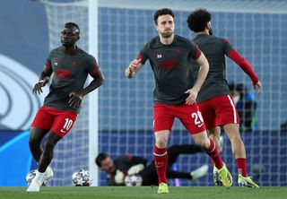 Liverpool’s Sadio Mane (left), Diogo Jota and Mohamed Salah warming up prior to kick-off during the UEFA Champions League match at the Alfredo Di Stefano Stadium, Madrid. Picture date: Tuesday April 6, 2021