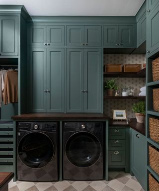 A laundry room with a black washer and dryer set, checkered floors, and wicker baskets