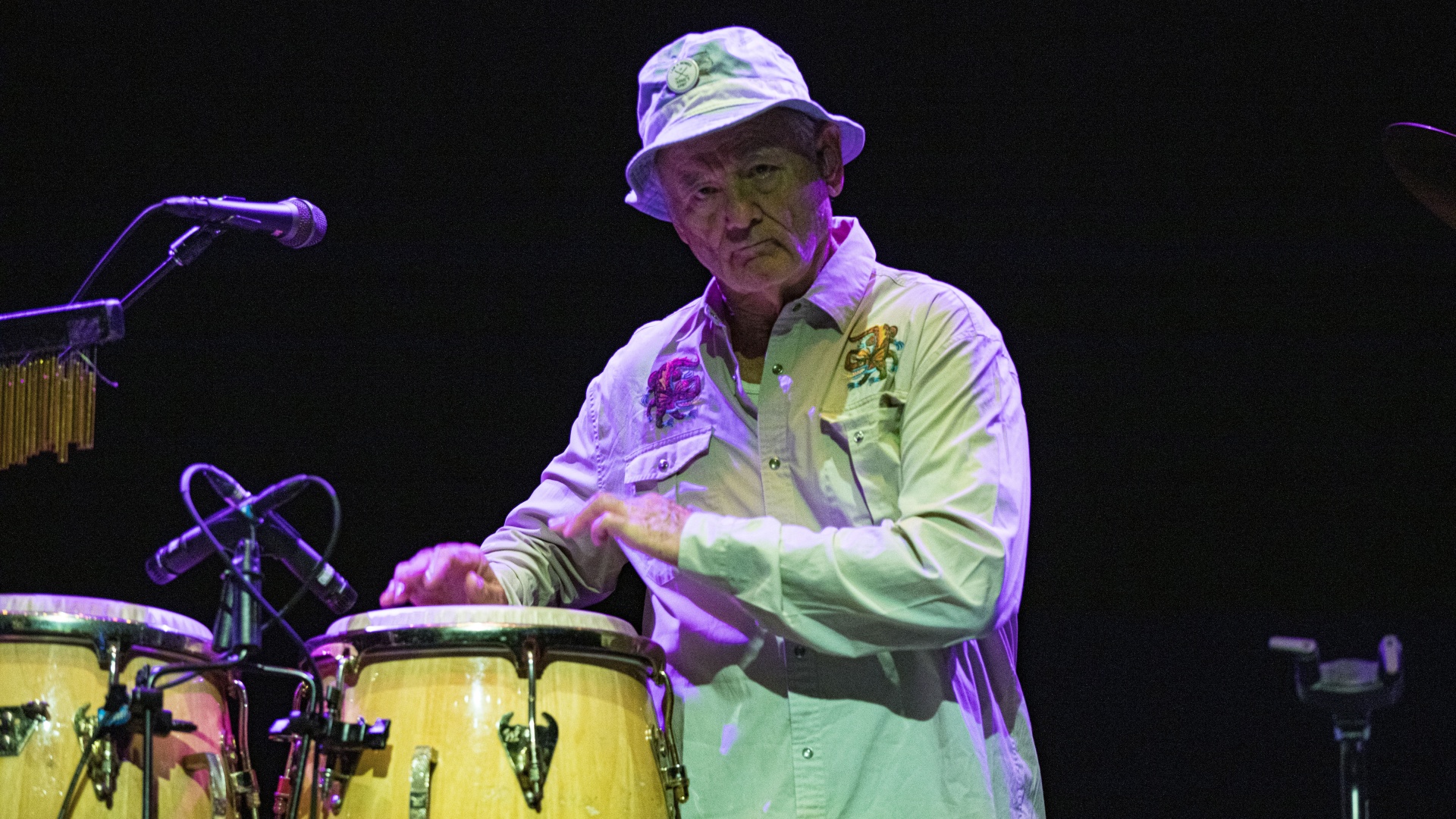 Bill Murray tapping on drums during a performance with his Blood Brothers