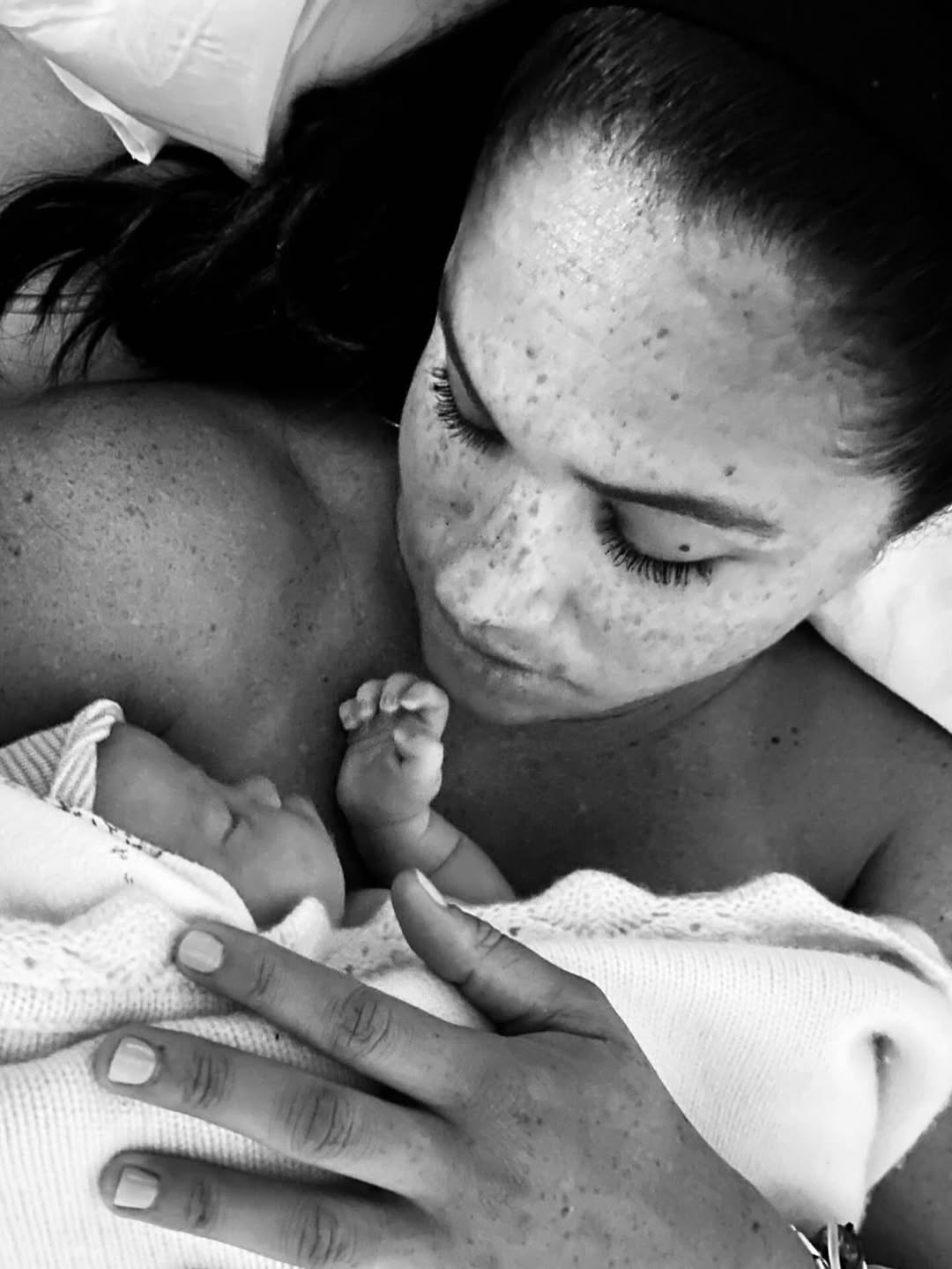 Meghan Markle holding newborn Princess Lilibet in bed