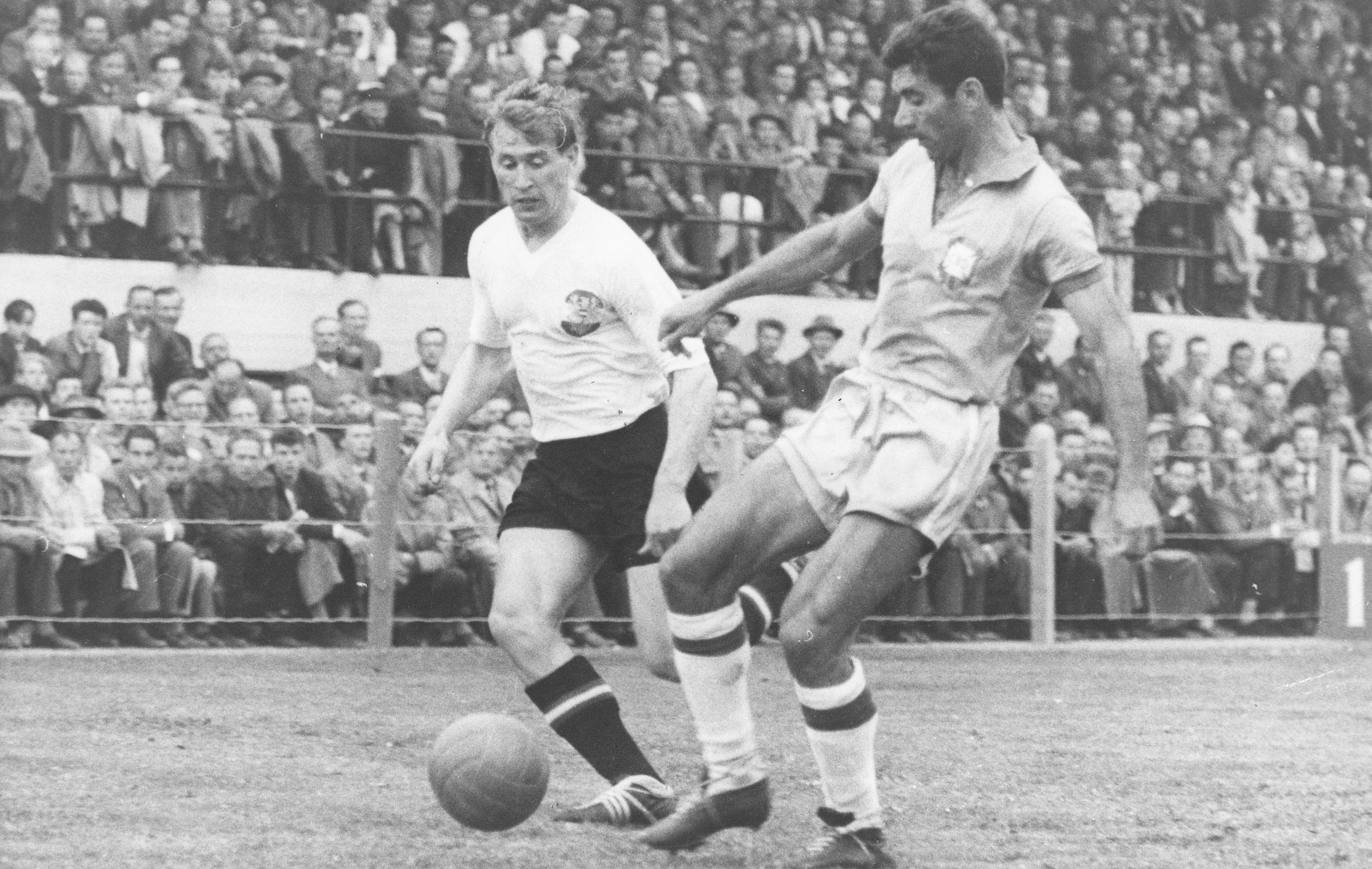 Sweden's Helmut Senekowitsch (left) and Brazil's Nilton Santos compete for the ball in the 1958 World Cup final.