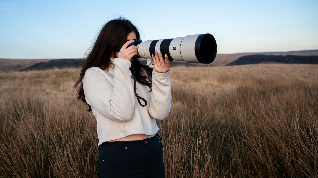 woman using the Sony FE 200-600 f/5.6-6.3 G OSS in a field