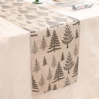 Christmas table runner with different sized trees on cream background