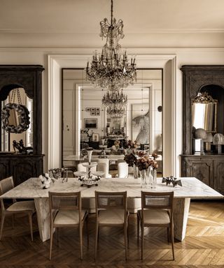 dining room with mirrored walls and parquet floors