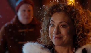 Doctor Who River Song stands in the snow with Nardole behind her