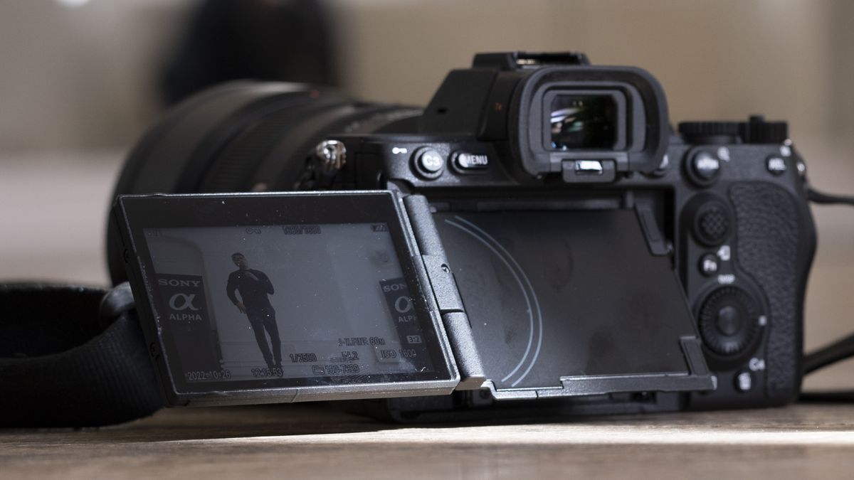 The Sony A7R V camera sitting on a wooden floor