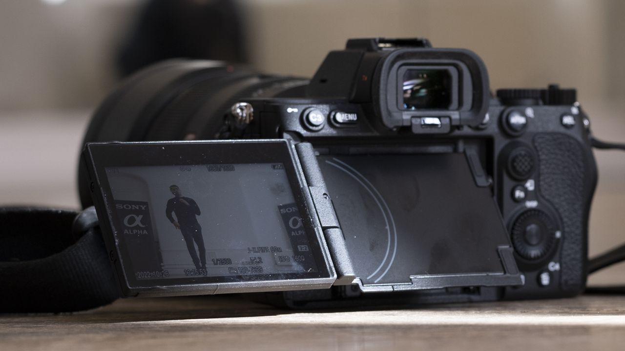 The Sony A7R V camera sitting on a wooden floor