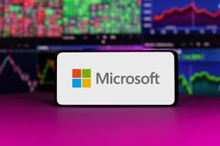 Microsoft logo on mobile phone screen company shares rise or fall on stock exchange market