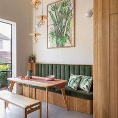 green seating area, wooden dining table and artwork