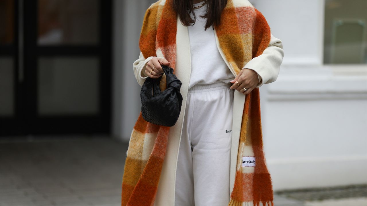 HAMBURG, GERMANY - JANUARY 14: Milena Karl wearing La Marel Jogger, Anine Bing coat, Acne Sudios scarf and Bottega Veneta bag on January 14, 2021 in Hamburg, Germany. (Photo by Jeremy Moeller/Getty Images)