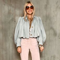 Sienna Miller wears pink trousers and a blue jacket.