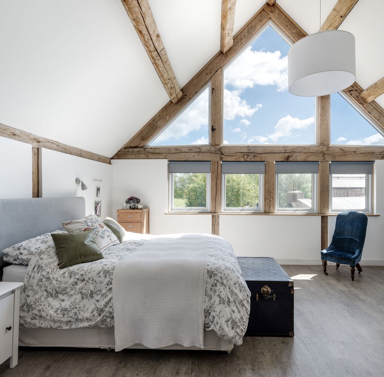 large bedroom with vaulted ceiling and windows